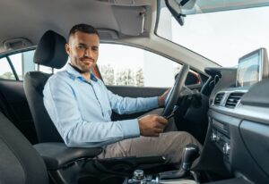 Young businessman at a car rental service preparing for a test drive